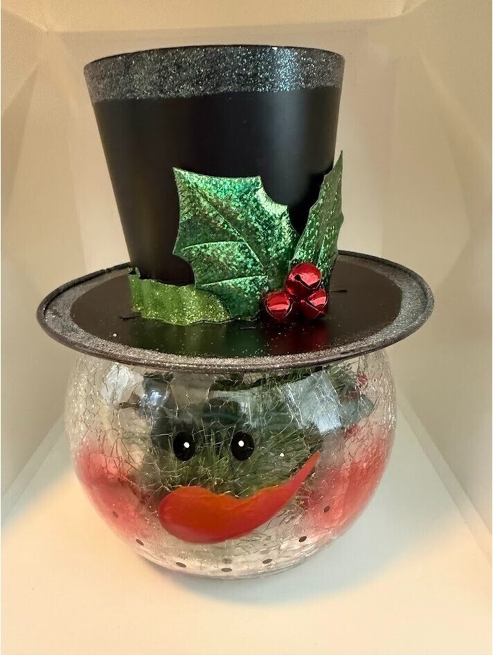 8 inch crackled round glass snowman with top hat. Lights inside with plug.